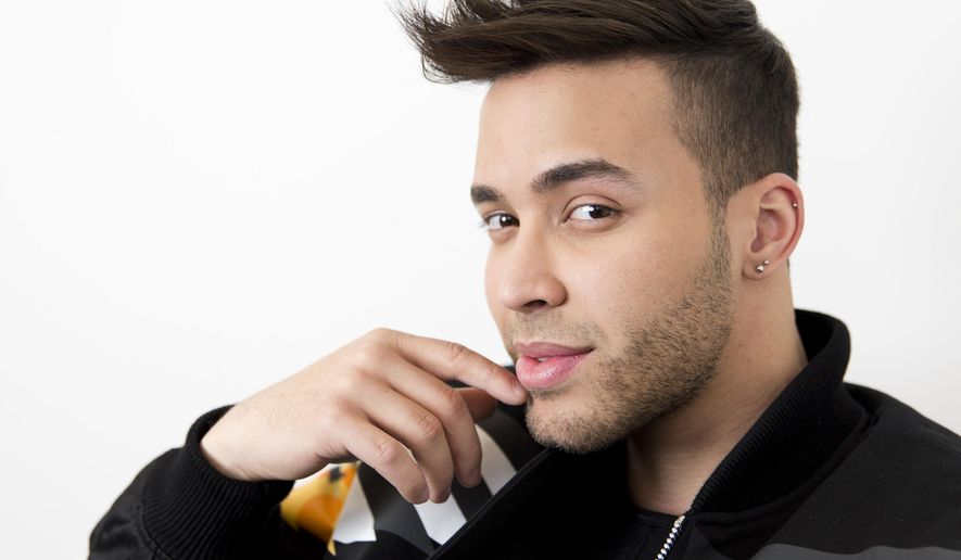 FILE - This Feb. 27, 2017 photo, singer Prince Royce poses for a photo in New York. Royce says he got a wake-up call with a COVID-19 diagnosis and now wants to try and wake others too. The Latin star told The Associated Press on Thursday that he is recovering from the virus. He says he decided to speak up out of a growing frustration with seeing people going out and gathering without protection. (Photo by Brian Ach/Invision/AP, File)
