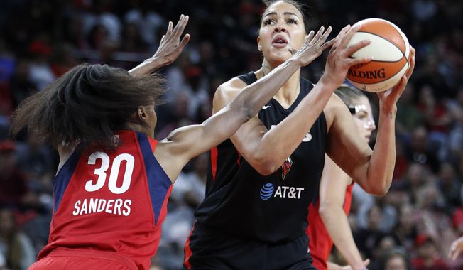 FILE - In this Tuesday, Sept. 24, 2019, file photo, Las Vegas Aces&#x27; Liz Cambage shoots against Washington Mystics&#x27; LaToya Sanders during the first half of Game 4 of a WNBA playoff basketball series in Las Vegas. All-Star center Cambage is expected to miss the upcoming 2020 WNBA season for health reasons, according to her agent. (AP Photo/John Locher, File)