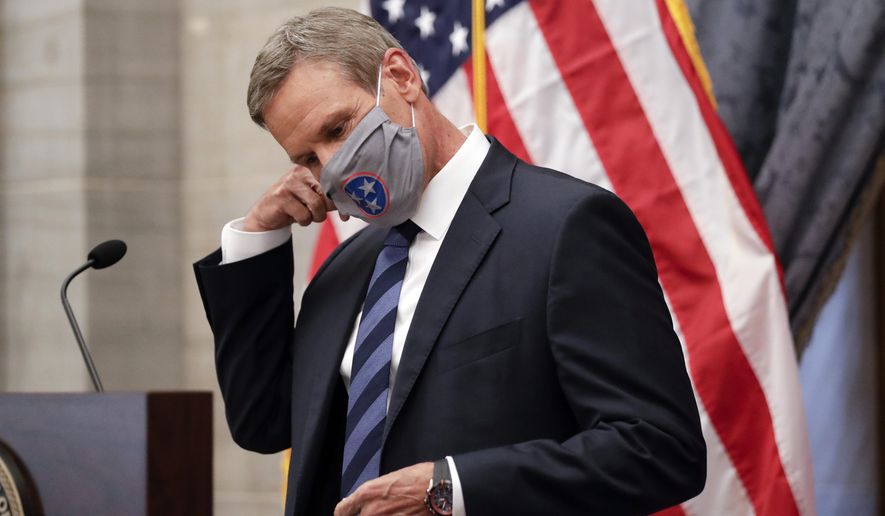 Tennessee Gov. Bill Lee removes his mask as he begins a news conference Wednesday, July 1, 2020, in Nashville, Tenn. (AP Photo/Mark Humphrey)