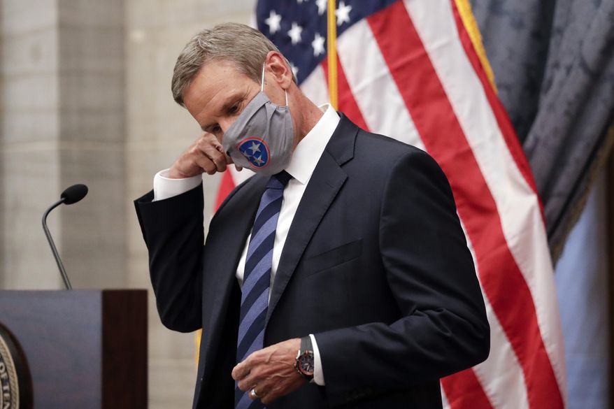 Tennessee Gov. Bill Lee removes his mask as he begins a news conference Wednesday, July 1, 2020, in Nashville, Tenn. (AP Photo/Mark Humphrey)