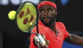 FILE - In this Tuesday, Jan. 21, 2020 file photo, Frances Tiafoe of the United States makes a backhand return to Russia&#x27;s Daniil Medvedev during their first round singles match at the Australian Open tennis championship in Melbourne, Australia. Frances Tiafoe has tested positive for the coronavirus and withdrawn from the All-American Team Cup tennis tournament. Tiafoe was scheduled to face Tennys Sandgren on Saturday, July 4, 2020 in the weekend tournament involving eight top American men’s players at Life Time Fitness in Peachtree Corners.(AP Photo/Lee Jin-man, File)
