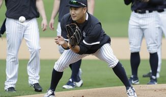 New York Yankees&#39; Masahiro Tanaka, of Japan, runs drills with teammates during  spring training baseball workout Thursday, Feb. 13, 2020, in Tampa, Fla. (AP Photo/Frank Franklin II)