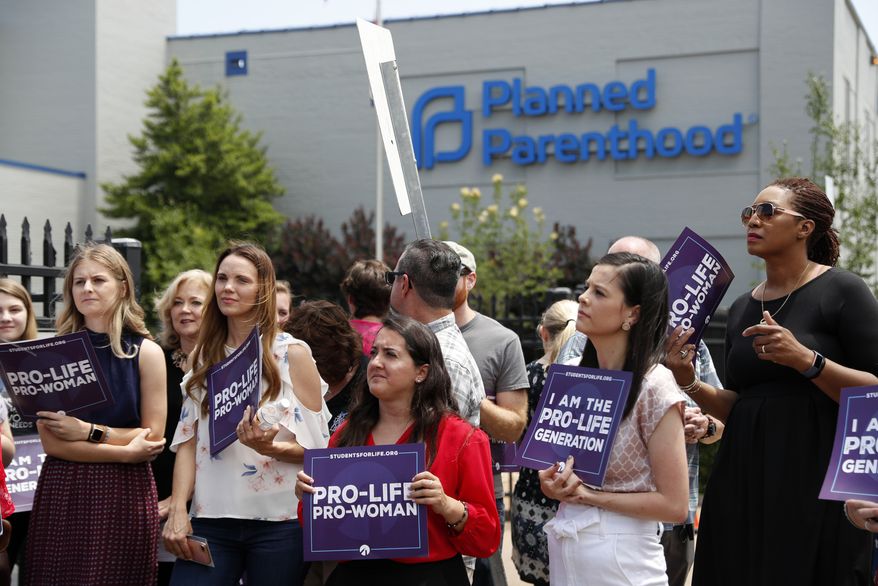 In this June 4, 2019, file photo, anti-abortion advocates gather outside the Planned Parenthood clinic in St. Louis. (AP Photo/Jeff Roberson, File)