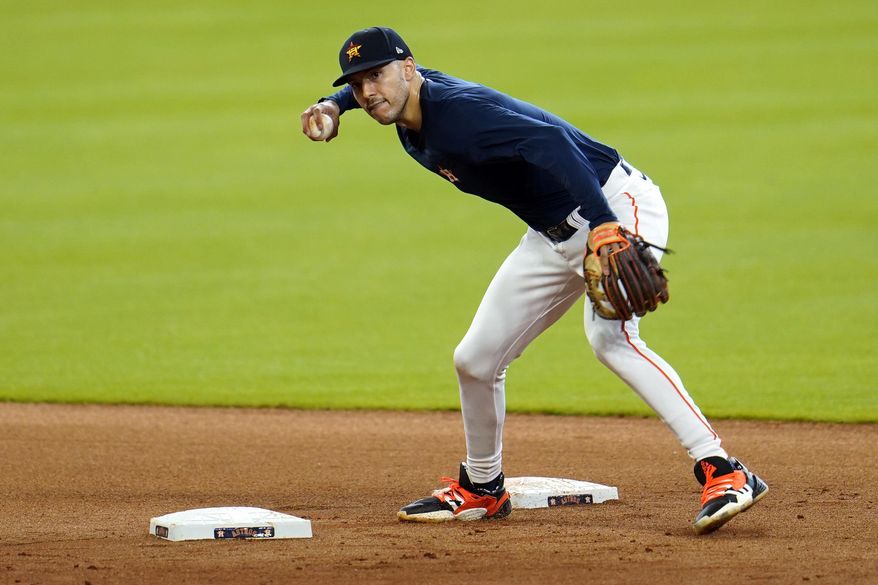 Houston Astros shortstop Carlos Correa runs through a drill during a baseball practice at Minute Maid Park, Sunday, July 5, 2020, in Houston. (AP Photo/David J. Phillip)