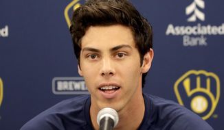 FILE - In this March 6, 2020, file photo, Milwaukee Brewers&#x27; Christian Yelich speaks after the Brewers announced his multi-year contract extension at the team&#x27;s spring training facility in Phoenix. Yelich acknowledges he benefited from fortunate timing in how he handled his contract negotiations. The Brewers held the March 6 news conference to announce that the 2018 NL MVP had agreed to a nine-year, $215 million contract. Spring training was halted due less than a week later due to the coronavirus. (AP Photo/Matt York, File)