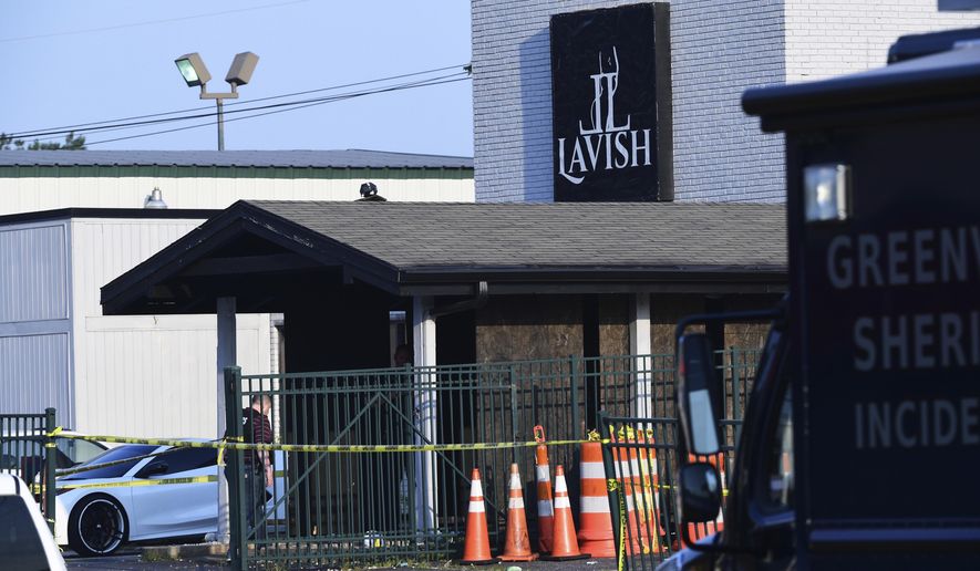 CORRECTS THE SOURCE TO KEN RUINARD WITH THE GREENVILLE NEWS - Yellow police tape can be seen outside of the Lavish Lounge in Greenville, S.C., Sunday, July 5, 2020, following a deadly shooting. (Ken Ruinard/The Greenville News via AP)