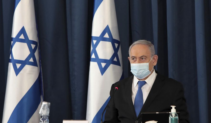 Israeli Prime Minister Benjamin Netanyahu wears a face mask to help prevent the spread of the coronavirus as he opens the weekly cabinet meeting, at the foreign ministry, in Jerusalem, Sunday, July 5, 2020. (Photo by Gali Tibbon/Pool via AP)