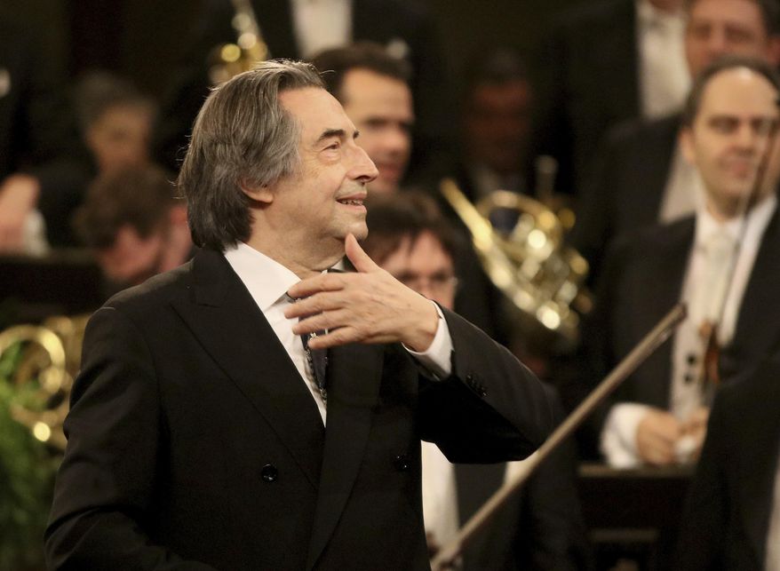FILE - In this Jan. 1, 2018 file photo, Italian Maestro Riccardo Muti conducts the Vienna Philharmonic Orchestra during the traditional New Year&#39;s concert at the golden hall of Vienna&#39;s Musikverein, Austria. Nine musicians from the Syrian diaspora in Europe are playing in the 24th friendship concert conducted by Riccardo Muti, this year at the Paestum archaeological site in southern Italy, but the coronavirus pandemic blocked others from arriving directly from Syria. (AP Photo/Ronald Zak, File)