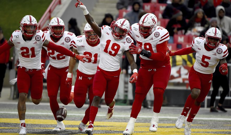 In this Saturday, Nov. 23, 2019, file photo, Nebraska safety Marquel Dismuke (19) celebrates with teammates after recovering a fumble from Maryland running back Javon Leake (20) during the first half of an NCAA college football game against Maryland, in College Park, Md. Nebraska&#39;s 24-sport program has about 600 athletes and is one of a handful that makes money. Though a 10% budget cut was announced recently, the program is able to absorb the cost of coronavirus testing, in part because of its affiliation with the university’s medical school.(AP Photo/Will Newton, File)  **FILE**