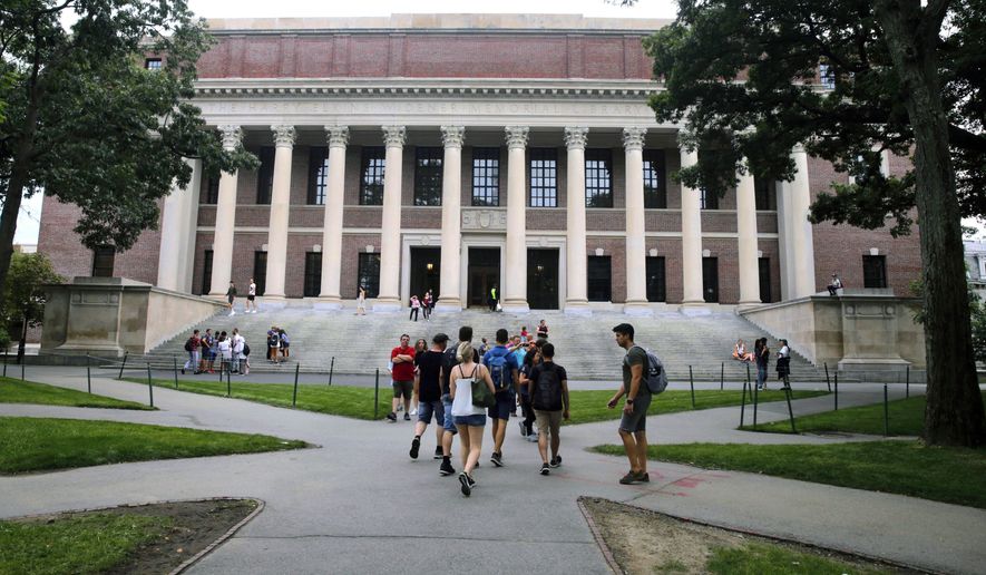 In this Aug. 13, 2019, file photo, students walk near the Widener Library in Harvard Yard at Harvard University in Cambridge, Mass. The Ivy League school announced Monday, July 6, 2020, that as the coronavirus pandemic continues its freshman class will be invited to live on campus this fall, while most other undergraduates will be required learn remotely from home. (AP Photo/Charles Krupa, File)