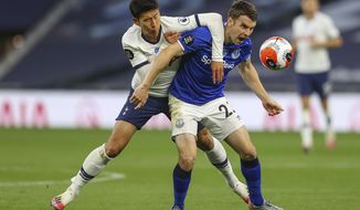 Tottenham&#39;s Son Heung-min, left, duels for the ball with Everton&#39;s Seamus Coleman during the English Premier League soccer match between Tottenham Hotspur and Everton FC at the Tottenham Hotspur Stadium in London, England, Monday, July 6, 2020. (Richard Heathcote/Pool via AP)