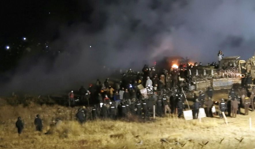 In this Nov. 20, 2016, file photo, provided by Morton County Sheriff&#x27;s Department, law enforcement and protesters clash near the site of the Dakota Access pipeline on Sunday, Nov. 20, 2016, in Cannon Ball, N.D. A federal judge on Monday, July 6, 2020, sided with the Standing Rock Sioux Tribe and ordered the Dakota Access pipeline to shut down until more environmental review is done. (Morton County Sheriff&#x27;s Department via AP, File)
