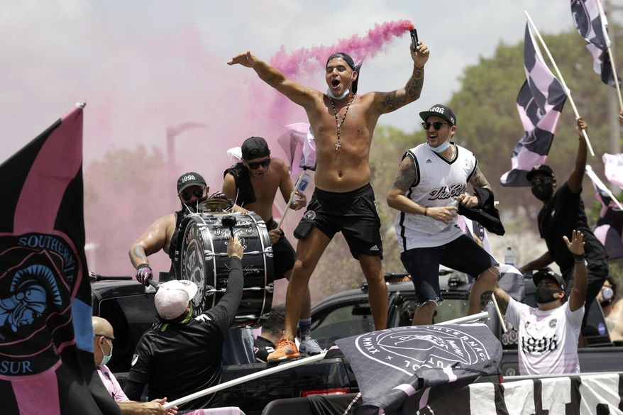 Fans of the Inter Miami CF soccer team reacts as the team leaves their stadium in Fort Lauderdale, Fla., Wednesday, July, 2020, as they head for a Major League Soccer tournament in Orlando. All 26 MLS teams will compete in a tournament in Orlando beginning July 8. The games will be the first time the league has been in action since play was shut down on March 12 because of the coronavirus. (AP Photo/Lynne Sladky)
