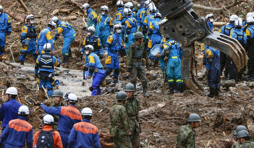 Rescuers search for missing persons at the site of a landslide in Tsunagi town, Kumamoto prefecture, southern Japan Monday, July 6, 2020. Rescue operations continued and rain threatened wider areas of the main island of Kyushu. (Takuto Kaneko/Kyodo News via AP)