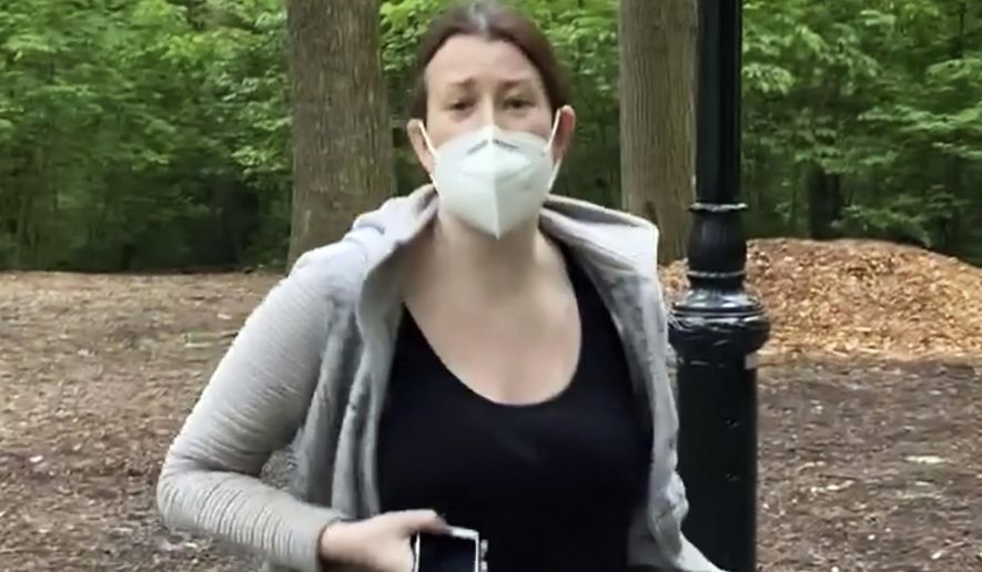 This file image made from May 25, 2020 video provided by Christian Cooper, shows Amy Cooper with her dog talking to Christian Cooper in Central Park in New York. Amy Cooper, walking her dog who called the police during a videotaped dispute with Christian Cooper, a Black man, was charged Monday, July 6, 2020, with filing a false report. (Christian Cooper via AP, File)