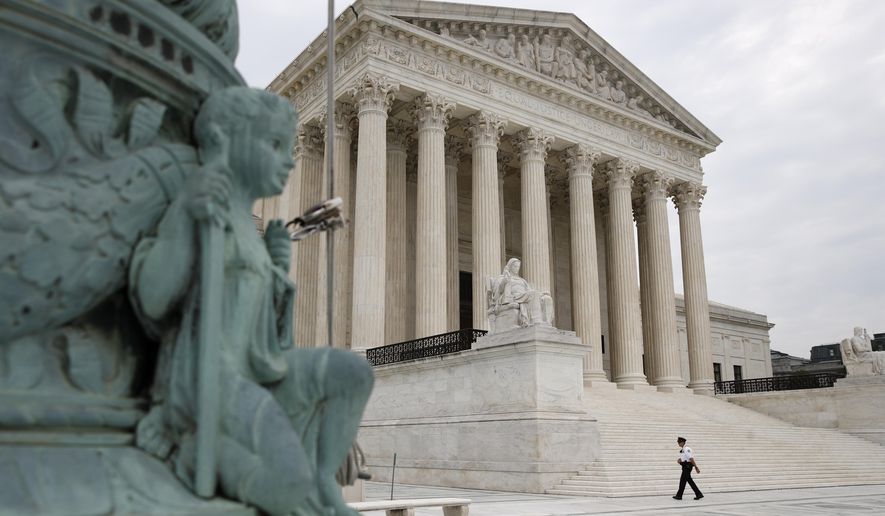 A police officer walks outside the Supreme Court on Capitol Hill in Washington, Monday, July 6, 2020. (AP Photo/Patrick Semansky)