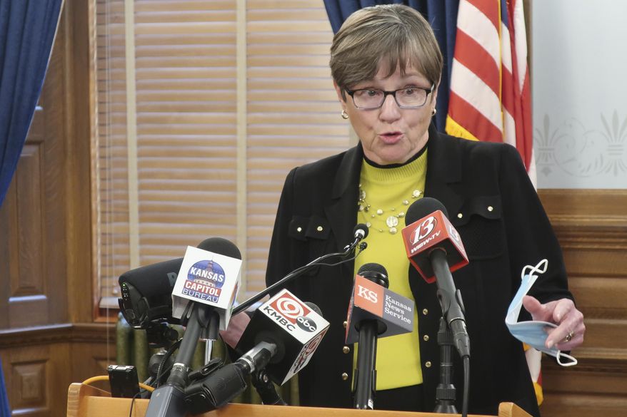 Kansas Gov. Laura Kelly speaks to reporters about the coronavirus pandemic during a news conference, Monday, July 6, 2020, at the Statehouse in Topeka, Kan. The state has seen its worst two-week spike in coronavirus cases since the pandemic began and Kelly is warning the public and local officials that wearing masks are necessary to check its spread. (AP Photo/John Hanna)