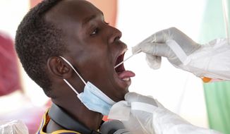 A member of the public is tested for the coronavirus in Bujumbura, Burundi Monday, July 6, 2020. Burundi launched a campaign of mass screening for COVID-19 on Monday in the country&#39;s largest city Bujumbura, indicating that the new president Evariste Ndayishimiye is implementing policies to combat the spread of the disease. (AP Photo/Berthier Mugiraneza)