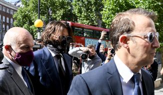 Johnny Depp, second left, wearing a protective mask arrives at the Royal Court of Justice, in London, Tuesday, July 7, 2020. Johnny Depp is suing a tabloid newspaper for libel over an article that branded him a &amp;quot;wife beater.&amp;quot; On Tuesday, a judge at the High Court is due to begin hearing Depp&#39;s claim against The Sun&#39;s publisher, News Group Newspapers, and its executive editor, Dan Wootton, over the 2018 story alleging he was violent and abusive to then-wife Amber Heard. Depp strongly denies the claim. (AP Photo/Alberto Pezzali)