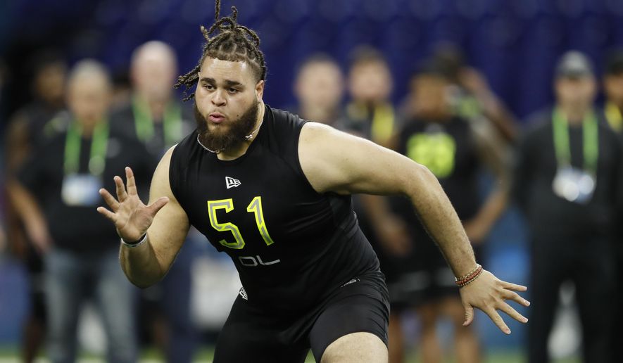 FILE - In this Feb. 28, 2020, file photo, Alabama offensive lineman Jedrick Wills runs a drill at the NFL football scouting combine in Indianapolis. The Cleveland Browns have signed rookie tackle Wills, their first-round draft pick who will try to slide over to the left side in the NFL. (AP Photo/Charlie Neibergall, File)