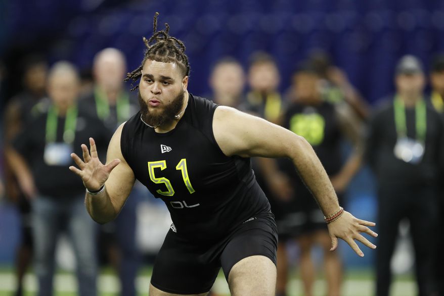 FILE - In this Feb. 28, 2020, file photo, Alabama offensive lineman Jedrick Wills runs a drill at the NFL football scouting combine in Indianapolis. The Cleveland Browns have signed rookie tackle Wills, their first-round draft pick who will try to slide over to the left side in the NFL. (AP Photo/Charlie Neibergall, File)