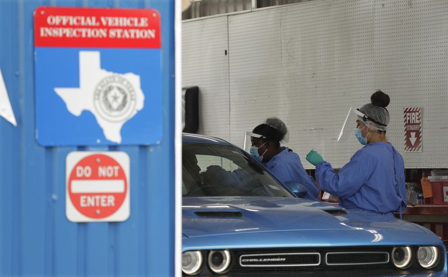 COVID-19 antibody testing and diagnostic testing are administered at a converted vehicle inspection station, Tuesday, July 7, 2020, in San Antonio. Local officials across Texas say their hospitals are becoming increasingly stretched and are in danger of becoming overrun as cases of the coronavirus surge. (AP Photo/Eric Gay)