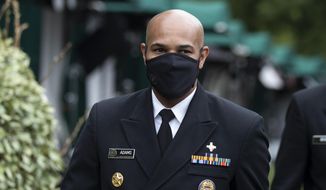 U.S. Surgeon General Jerome Adams departs after a television interview on the North Lawn of the White House, Tuesday, July 7, 2020, in Washington. (AP Photo/Alex Brandon)