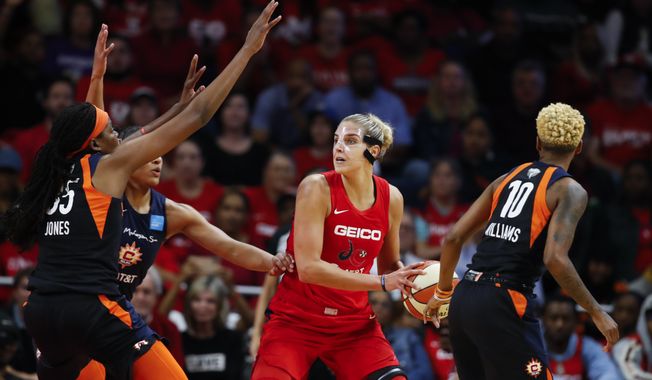 In this Oct. 10, 2019, file photo, Connecticut Sun forward Jonquel Jones, left, and guard Courtney Williams, right, huard Washington Mystics forward Elena Delle Donne during the first half of Game 5 of basketball&#x27;s WNBA Finals in Washington. Delle Donne is waiting to have her case heard by the league&#x27;s independent panel of doctors to see if she&#x27;ll be medically excused for the season, according to the Mystics. The Mystics star, who was the league Most Valuable Player last year, has battled Lyme Disease since 2008 and would potentially be at a higher risk for serious illness if she contracted the new coronavirus. (AP Photo/Alex Brandon, File)  **FILE**