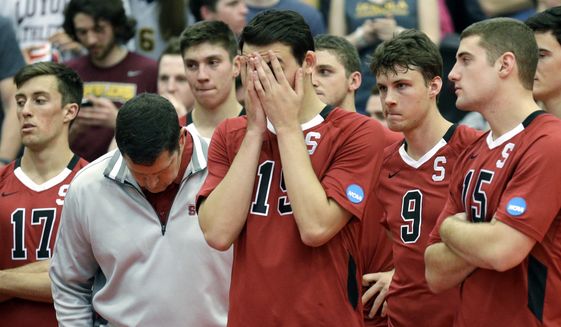  In this May 3, 2014, file photo, Stanford men&#39;s volleyball head coach John Kosty, second from left, looks down as players react after a 3-1 loss to Loyola in the NCAA men&#39;s college volleyball championship at Gentile Arena in Chicago. Stanford announced Wednesday, July 8, 2020,  that it is dropping 11 sports amid financial difficulties caused by the coronavirus pandemic. The school will discontinue men’s and women’s fencing, field hockey, lightweight rowing, men’s rowing, co-ed and women’s sailing, squash, synchronized swimming, men’s volleyball and wrestling after the 2020-21 academic year. Stanford also is eliminating 20 support staff positions. (AP Photo/Nam Y. Huh, File)  **FILE**