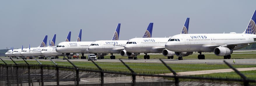 In this March 25, 2020, file photo, United Airlines planes are parked at George Bush Intercontinental Airport in Houston. (AP Photo/David J. Phillip, File)
