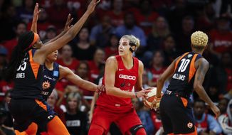 In this Oct. 10, 2019, file photo, Connecticut Sun forward Jonquel Jones, left, and guard Courtney Williams, right, guard Washington Mystics forward Elena Delle Donne during the first half of Game 5 of basketball&#39;s WNBA Finals in Washington. Delle Donne is waiting to have her case heard by the league&#39;s independent panel of doctors to see if she&#39;ll be medically excused for the season, according to the Mystics.The Mystics star, who was the league Most Valuable Player last year, has battled Lyme Disease since 2008 and would potentially be at a higher risk for serious illness if she contracted the new coronavirus. (AP Photo/Alex Brandon) ** FILE **