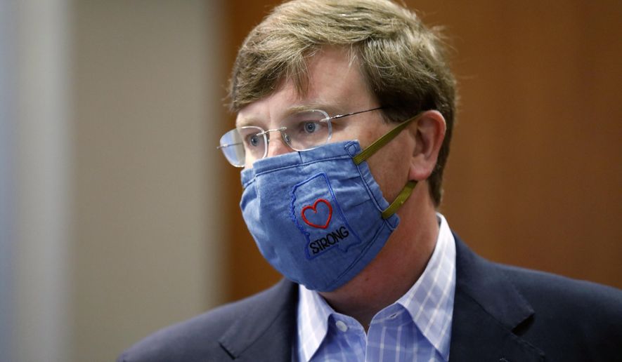 Gov. Tate Reeves sports a "Mississippi Strong" face mask following his coronavirus news briefing in Jackson, Miss., Wednesday, July 8, 2020. Reeves and other state officials provided reporters an update on the coronavirus and the state's ongoing strategy to limit transmission. (AP Photo/Rogelio V. Solis)