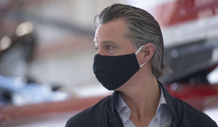 California Gov. Gavin Newsom visits the Cal Fire McClellan Reload Base in Sacramento, Calif., Thursday, July 9, 2020, to discuss the state&#39;s new efforts to protect emergency personnel and evacuees from COVID-19 during wildfires. (AP Photo/Hector Amezcua, Pool)