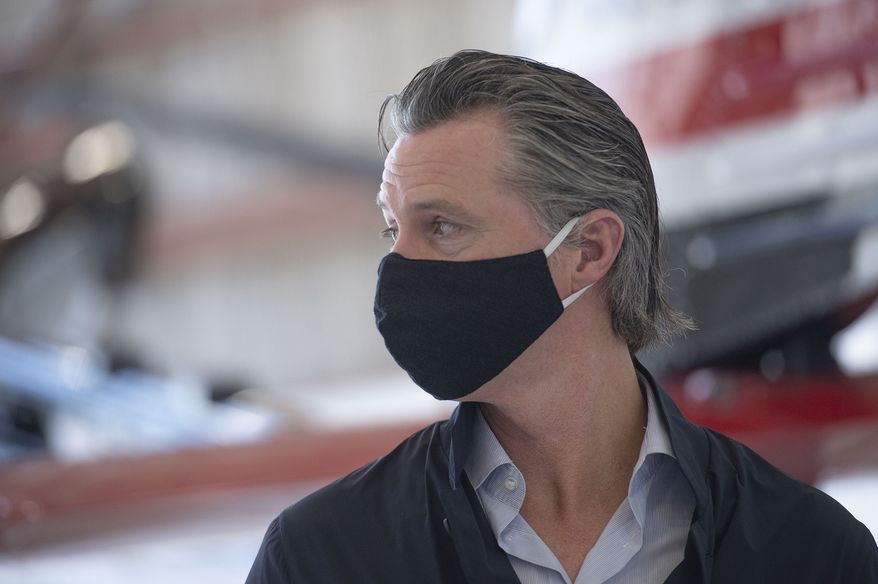 California Gov. Gavin Newsom visits the Cal Fire McClellan Reload Base in Sacramento, Calif., Thursday, July 9, 2020, to discuss the state&#39;s new efforts to protect emergency personnel and evacuees from COVID-19 during wildfires. (AP Photo/Hector Amezcua, Pool)