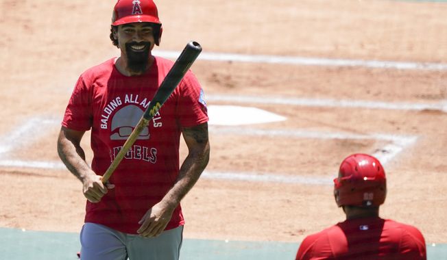 Los Angeles Angels&#x27; Anthony Rendon smiles after batting during practice at Angels Stadium on Friday, July 3, 2020, in Anaheim, Calif. (AP Photo/Ashley Landis)
