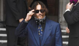 Johnny Depp arrives at the High Court in London, Thursday, July 9, 2020. Johnny Depp is back in the witness box for a third day at the trial of his libel suit against a tabloid newspaper that called him a “wife-beater.” Depp is suing News Group Newspapers, publisher of The Sun, and the paper’s executive editor, Dan Wootton, over an April 2018 article that said he’d physically abused ex-wife Amber Heard.  He strongly denies ever hitting Heard. (AP Photo/Alberto Pezzali)