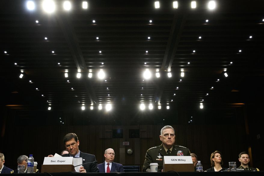 In this March 4, 2020, file photo Defense Secretary Mark Esper, left, and Chairman of the Joint Chiefs of Staff Gen. Mark Milley, listen during a Senate Armed Services Committee on budget posture on Capitol Hill in Washington. Esper and Milley are going before Congress for the first time in months to face a long list of controversies, including their differences with President Donald Trump over the handling of protests near the White House last month during unrest triggered by the killing George Floyd in police hands. (AP Photo/Jacquelyn Martin, File)