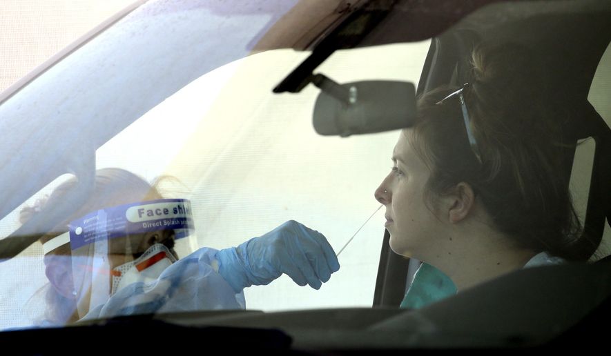 People get tested at a drive thru coronavirus testing site at South Mountain Community College, Thursday, July 9, 2020, in Phoenix. (AP Photo/Ross D. Franklin)