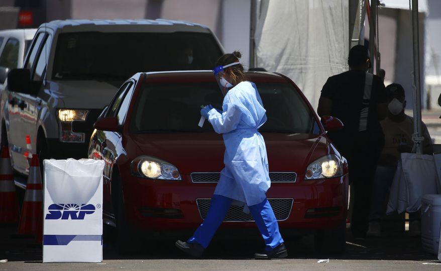 People get tested at a drive-thru coronavirus testing site at South Mountain Community College, Thursday, July 9, 2020, in Phoenix. (AP Photo/Ross D. Franklin)