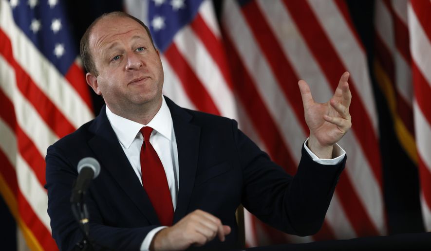 Colorado Governor Jared Polis makes a point during a news conference on the state's efforts to contain the spread of the new coronavirus, Thursday, July 9, 2020, in Denver. (AP Photo/David Zalubowski)