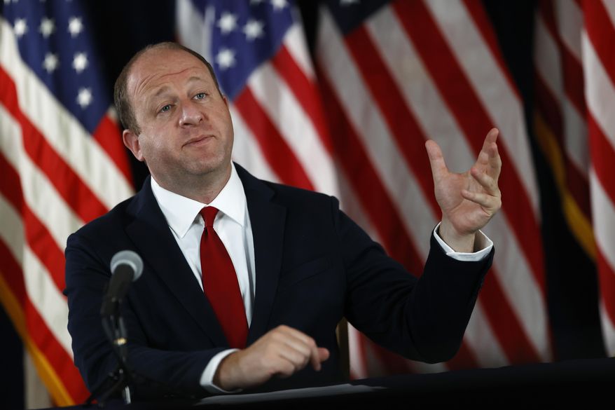 Colorado Governor Jared Polis makes a point during a news conference on the state's efforts to contain the spread of the new coronavirus, Thursday, July 9, 2020, in Denver. (AP Photo/David Zalubowski)
