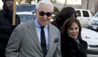 FILE - In this Nov. 14, 2019, file photo, Roger Stone accompanied by his wife Nydia Stone, right, arrives at federal court in Washington. (AP Photo/Jose Luis Magana, File)