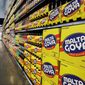 In this April 29, 2015, file photo, people walk past displays of Goya Foods products at the new corporate headquarters in Jersey City, N.J. Goya Foods is facing a swift backlash after its CEO Robert Unanue praised President Donald Trump at White House event on Thursday, July 9, 2020. After a social media push to boycott Goya Foods, many prominent conservatives took to Twitter to say they were going to buy even more of the company's products then they usually do. (AP Photo/Mel Evans, File) ** FILE **