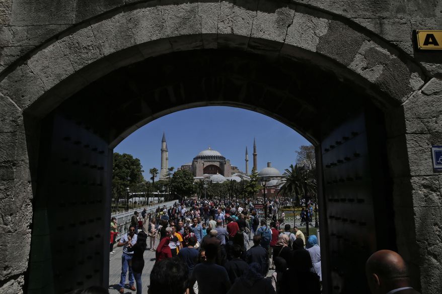 In this Sunday, May 10, 2015 file photo, visitors walk towards the Byzantine-era Hagia Sophia, an UNESCO World Heritage site and one of Istanbul&#x27;s main tourist attractions in the historic Sultanahmet district of Istanbul. Turkey&#x27;s Council of State, the country&#x27;s highest administrative court is expected Friday, July 10, 2020, to release a ruling on a petition requesting that a1934 decision that turned the Hagia Sophia into a museum be annulled.(AP Photo/Lefteris Pitarakis, FILE)  **FILE**