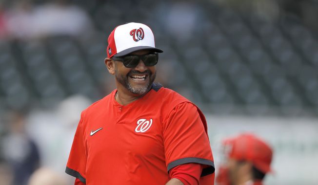In this March 10, 2020, file photo, Washington Nationals manager Dave Martinez reacts while walking back to the dugout after pulling starting pitcher pitcher Ben Braymer during the third inning of a spring training baseball game against the Miami Marlins in Jupiter, Fla. &amp;quot;The first thing you want to do when you see the guys come in after not seeing them for a while, you want to give them a big hug, a fist bump, high-five,&amp;quot; Martinez said Friday, July 3. &amp;quot;Had to stop myself today from almost spitting in my mask because I drank some water. You&#x27;re just used to it.&amp;quot; (AP Photo/Julio Cortez, File)  **FILE**