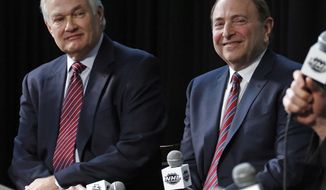 FILE - In this Jan. 24, 2015, file photo, NHL Player&#39;s Association executive director Donald Fehr, left, and NHL Commissioner Gary Bettman attend a news conference at Nationwide Arena in Columbus, Ohio. Given the gravity of the pandemic and the abrupt decision to place the NHL season on pause in March, it did not take Bettman and Fehr long to realize they were going to have to work together if play was to resume any time soon. (AP Photo/Gene J. Puskar, File)