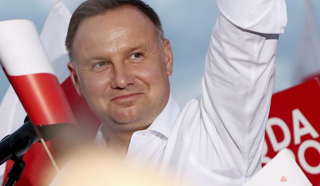 In this Tuesday, July 7, 2020 photo Poland&#x27;s incumbent president Andrzej Duda, who is seeking reelection in a tight presidential election runoff on Sunday, July 12, 2020 attends a rally in Lomza, Poland. Duda, who has backing from Poland&#x27;s ruling right-wing party, is running against liberal Warsaw mayor, Rafal Trzaskowski. Opinion polls suggest the election may be decided by a small number of votes. (AP Photo/Czarek Sokolowski)