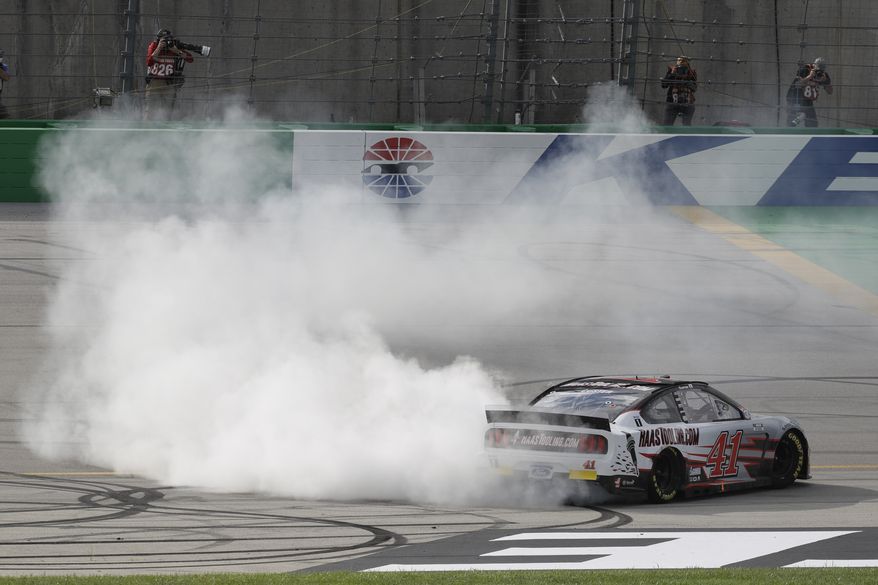 Cole Custer (41) celebrates after winning a NASCAR Cup Series auto race Sunday, July 12, 2020, in Sparta, Ky. (AP Photo/Mark Humphrey)