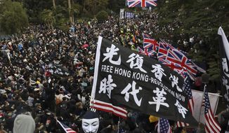 FILE - In this Sunday, Jan. 19, 2020 file photo, participants wave British and U.S. flags during a rally demanding electoral democracy and call for boycott of the Chinese Communist Party and all businesses seen to support it in Hong Kong. Only five years ago, former British Prime Minister David Cameron was celebrating a “golden era” in U.K.-China relations, bonding with President Xi Jinping over a pint of beer at the pub and signing off trade deals worth billions. Those friendly scenes now seem like a distant memory, with hostile rhetoric ratcheting up this week over Beijing’s new national security law on Hong Kong. China has threatened “consequences” after Britain offered refuge to millions in the former colony. (AP Photo/Ng Han Guan, file)