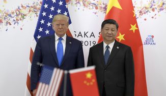 In this June 29, 2019, photo President Donald Trump, left, poses for a photo with Chinese President Xi Jinping during a meeting on the sidelines of the G-20 summit in Osaka, Japan. China has fast become a top election issue as President Donald Trump and Democrat Joe Biden engage in a verbal brawl over who&#x27;s better at playing the tough guy against Beijing. (AP Photo/Susan Walsh) **FILE**